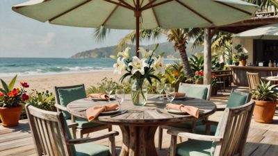Outdoor beachside dining setup with floral centerpiece.
