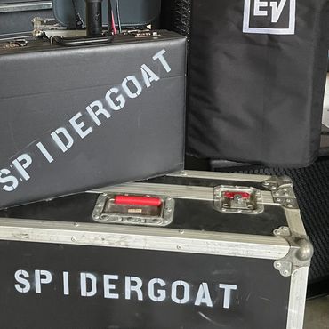 Stacked black cases labeled SPIDERGOAT and an EV speaker cover.