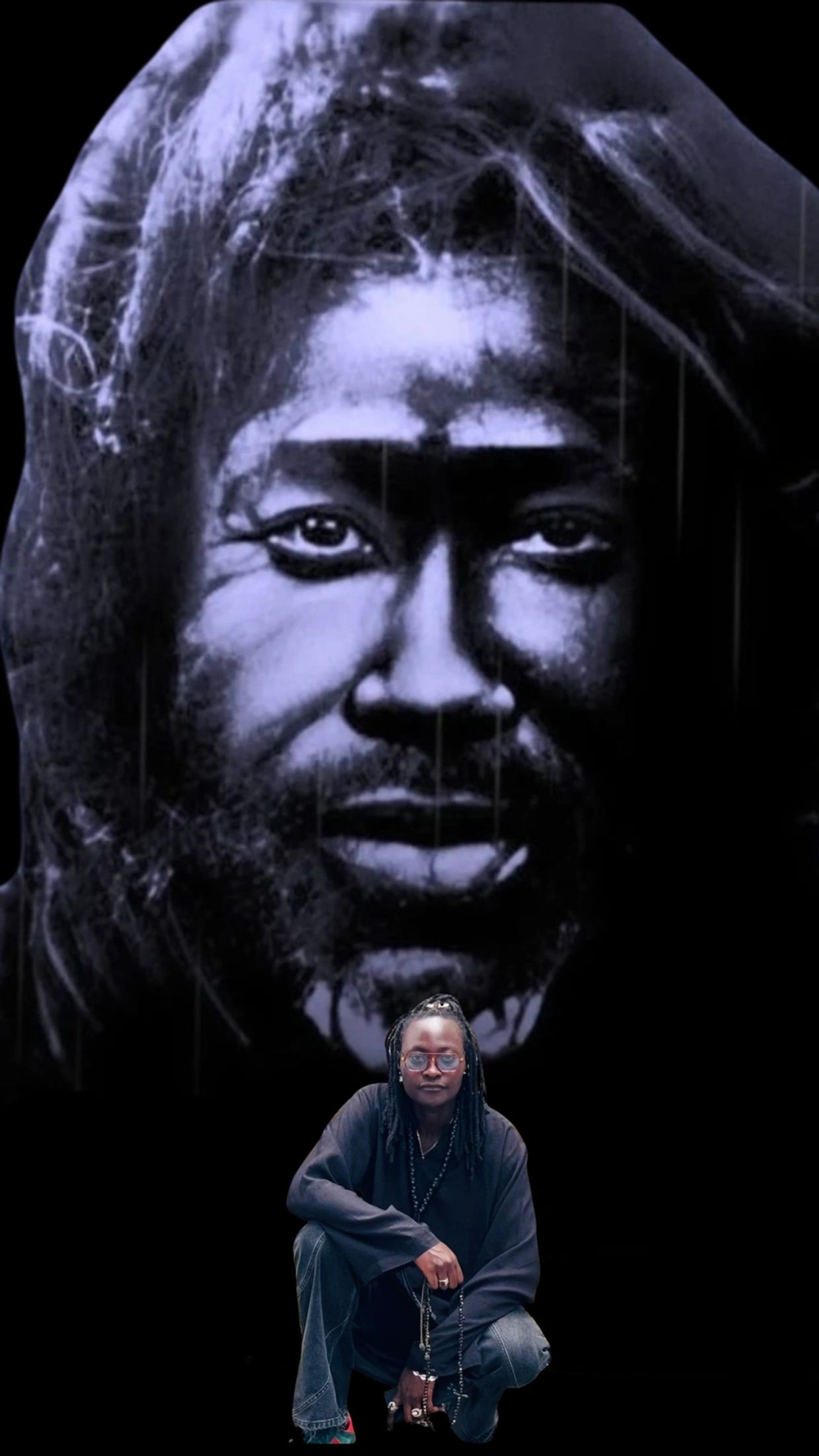 Person crouches in front of a large monochrome mural of a contemplative face.