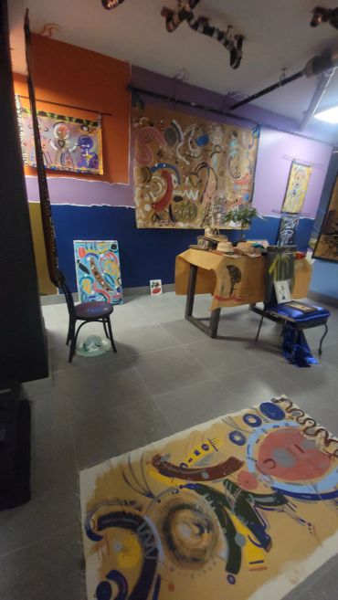 A colorful room with abstract paintings and furniture with a similar design.