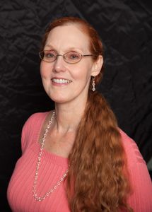 Bust of Dr. Red with long, flowing red hair and glasses.