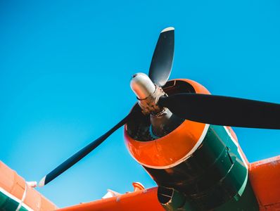 Close-up of airplane propeller against blue sky.