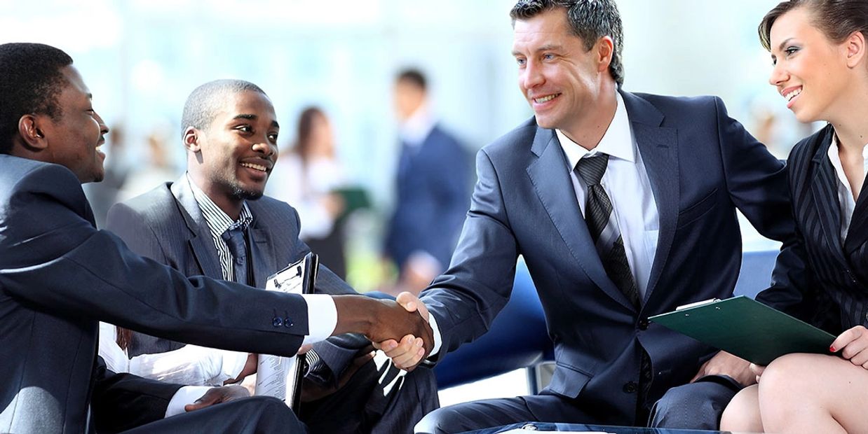 Business professionals shaking hands in a meeting.