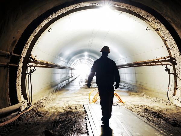 Silhouette of a worker in a tunnel.