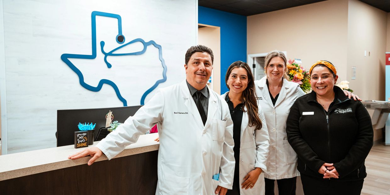 Group of medical professionals smiling in a clinic.