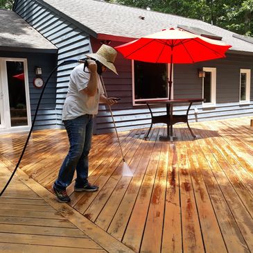 Stain-stripping and pressure washing wood deck floor in Glen Allen, VA by Southern Home Handyman.