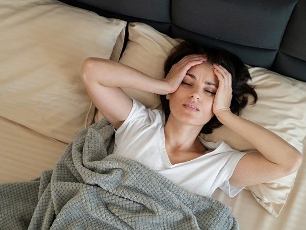 sick-woman-laying-bed-medium-shot