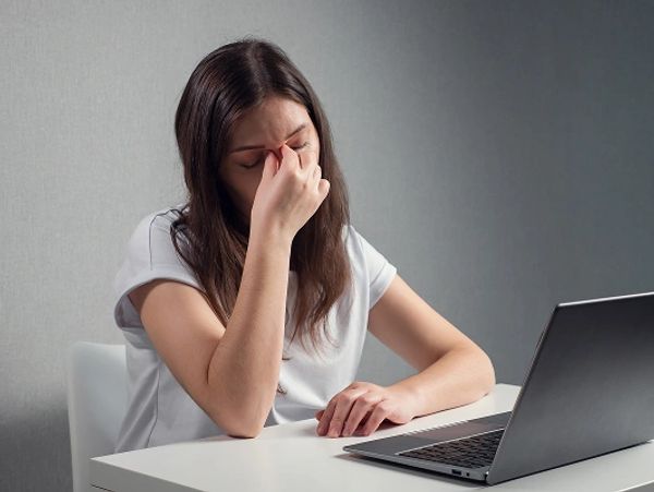young-woman-massaging-bridge-nose-eyes-while-sitting-front-laptop