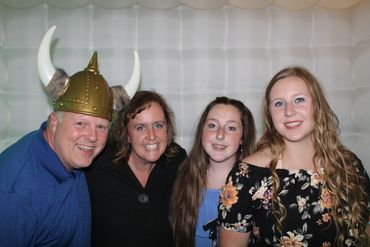 family inside a big shot inflatable photo booth