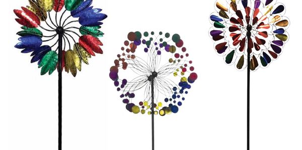 Three colorful metal wind spinners with various designs on a white background.