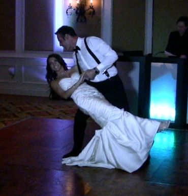 wedding first dance performance, man dipping dance partner, groom and bride dancing,