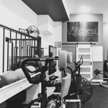 Home gym featuring a weight rack, rowing machine