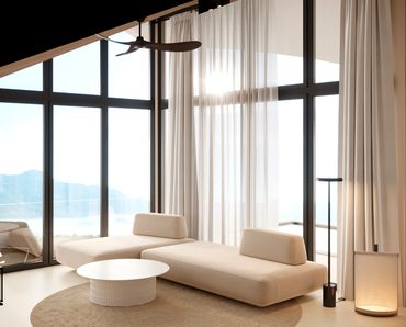 Bright modern living room with beige sofa and large windows.