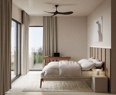 Minimalist bedroom with natural light and neutral tones.