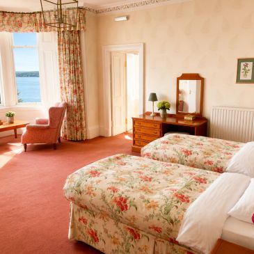 Cozy bedroom with twin beds and a sea view.