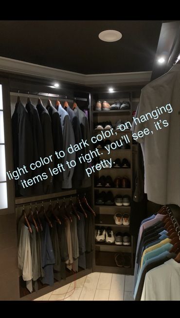 Closet with clothes hung from light to dark colors, organized and neat.