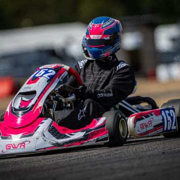 Go-kart racer in action on the track.
