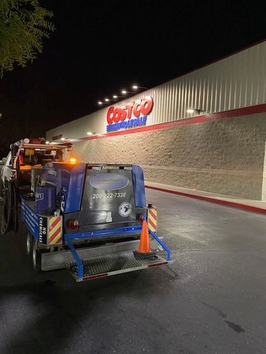 Night project to remove red curb paint at Costco store in Merced, CA