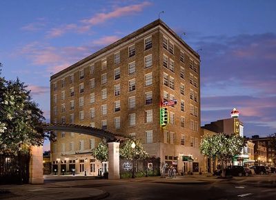 Historic LaSalle Hotel building illuminated at dusk in a charming downtown area.