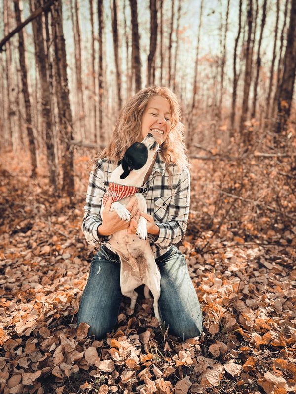 Auntie Tanya holding pocket beagle wearing custom Cornerbrooks bandana. Dog licking Aunties chin