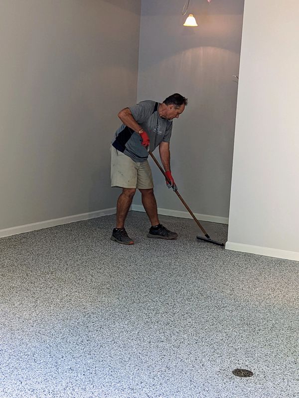 Ted using squegee on epoxy floor installtion