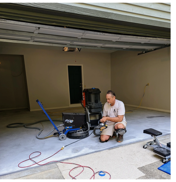 Ted with diamond grinder and HEPA vac used to prep floor for epoxy floor coating.