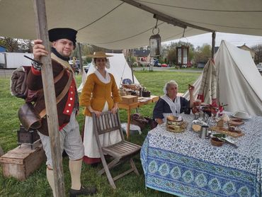 Living History camp setup with food display.