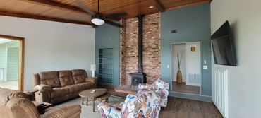 Teal and white two story livingroom with wood ceiling in Hot Springs, AR