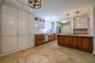 Professionally painted kitchen with white painted cabinets and stained island.