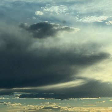 Dramatic cloudy sky with sunlight breaking through.