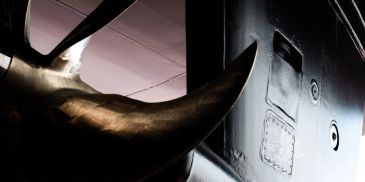 Close-up of a propeller and part of a submarine.