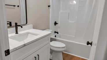 Full bathroom with quartz vanity, N Jefferson St student townhome