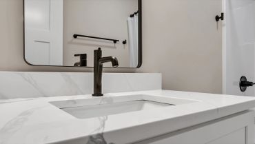 Modern bathroom faucet and vanity detail, N Jefferson St student townhome