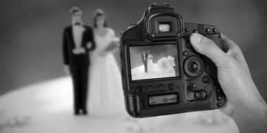 Wedding Photography: Photographer focusing on a bride and groom, capturing wedding moments.