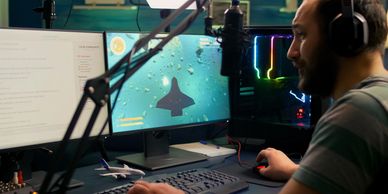 VFX artist editing cinematic effects on dual screens with stylus and microphone.