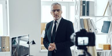 A camera capturing a businessman in a modern office, highlighting corporate elements for branding