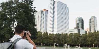 Architectural Photography: Photographer capturing modern buildings, stunning architectural shots.