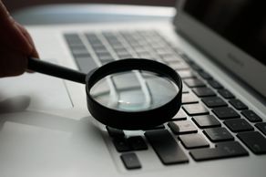 Image of magnifying glass on a computer keyboard