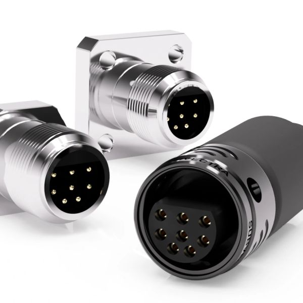 Close-up of three circular metal connectors with pins.