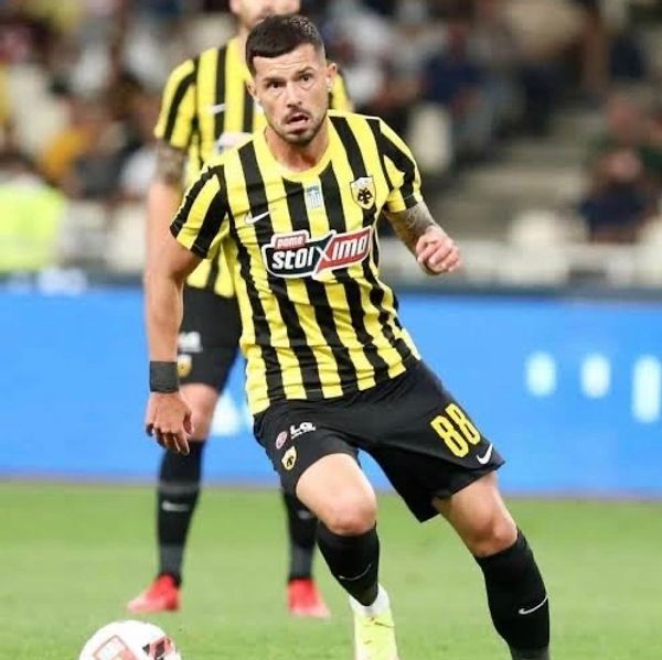Soccer player in a yellow and black striped jersey controlling the ball on the field.