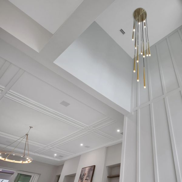 Modern ceiling with elegant hanging lights and detailed molding.
