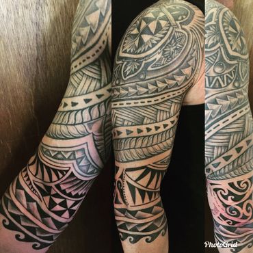 Black and grey tribal sleeve tattoos.
