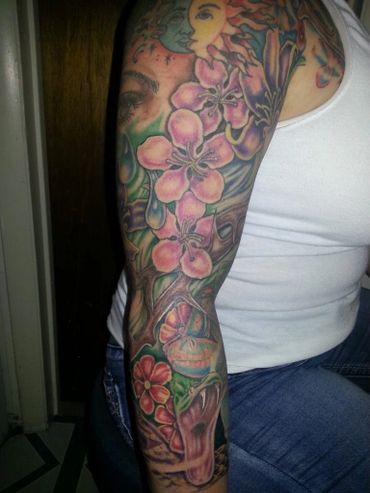Color sleeve tattoo with flowers.