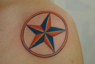 Color tattoo of a star with a ring around it.