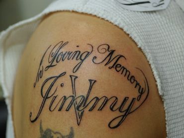 Lettering tattoo on shoulder.