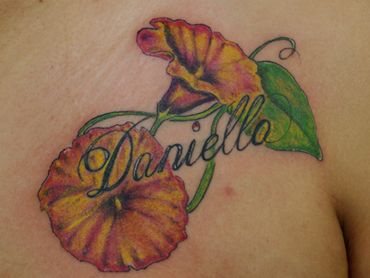 Color flowers tattoo with a name.