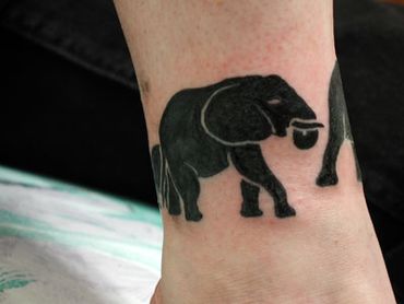 Black and grey tribal elephant tattoo.