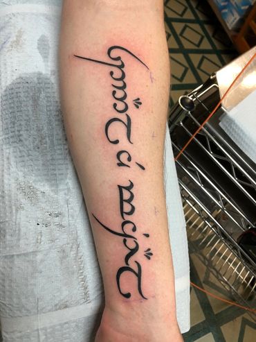 Lettering tattoo on inner arm.