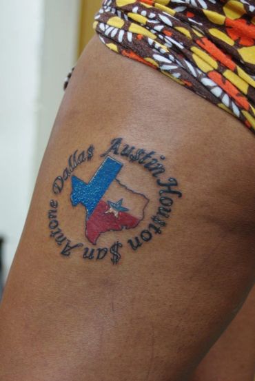 Color tattoo of Texas with lettering.