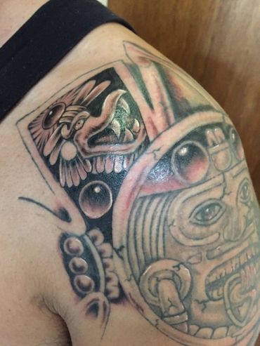 Black and grey Aztec shoulder tattoo.